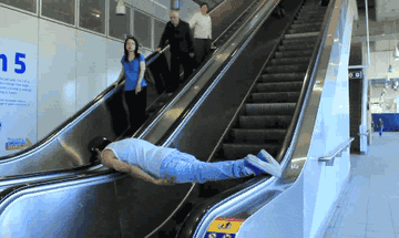 Man planking up an escalator