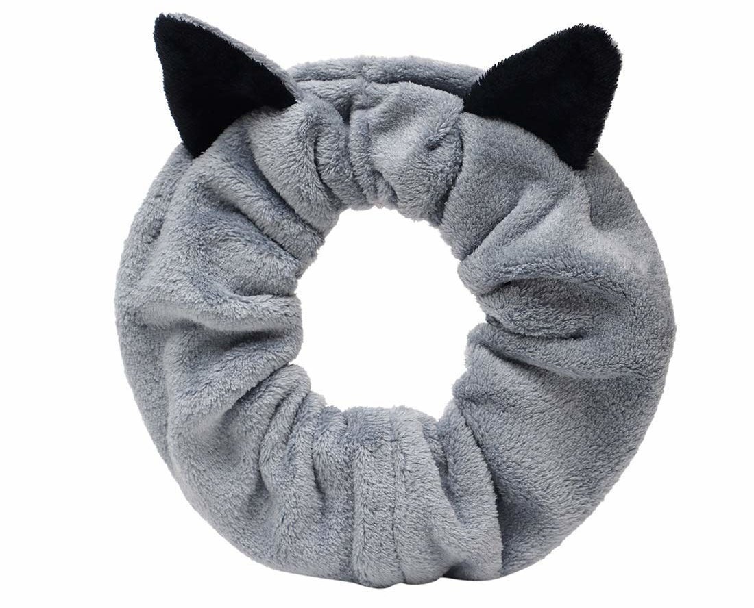A grey hair band with black cat ears
