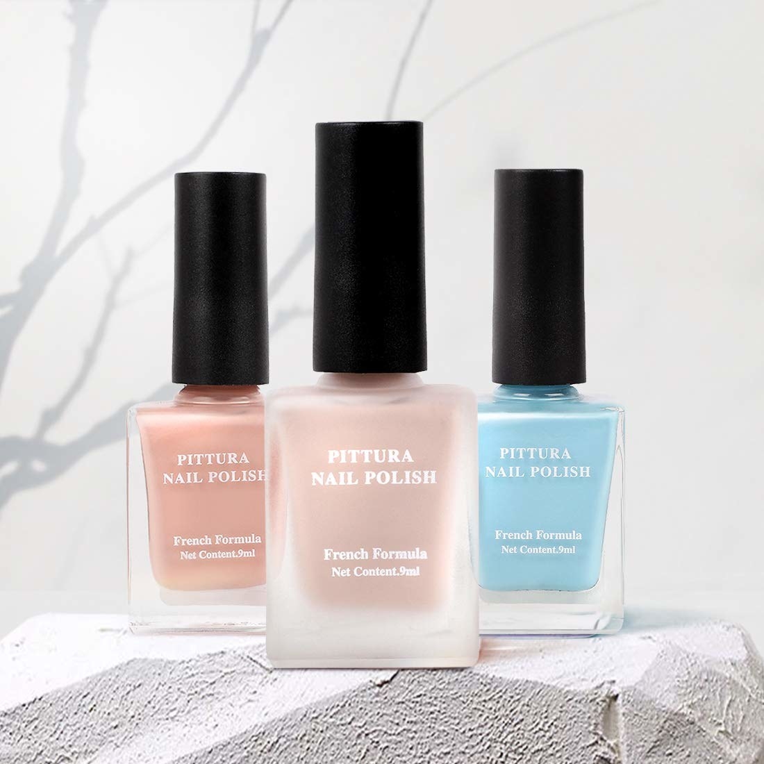3 different glossy nail polishes from Miniso in the shades peachy beige, light blue and matte nude