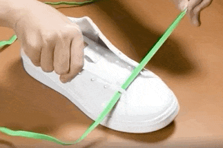 a gif of a model installing the magnetic laces on a pair of sneakers 