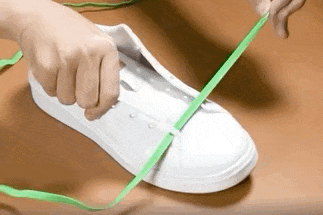 a gif of a model installing the magnetic laces on a pair of sneakers 
