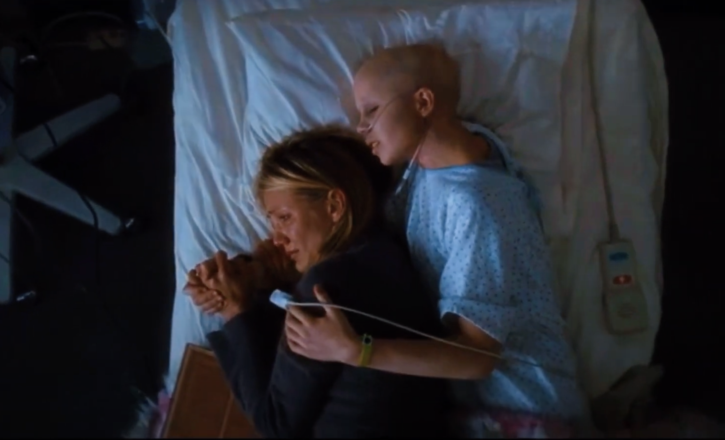 Kate hugging her mom in her hospital bed