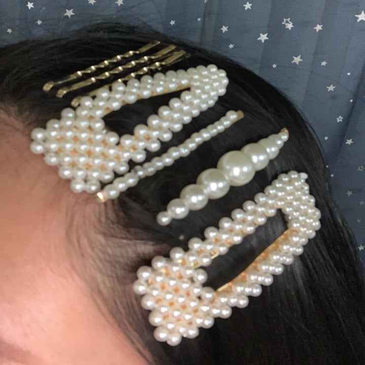 reviewer wearing several pearl hair clips and gold bobby pins