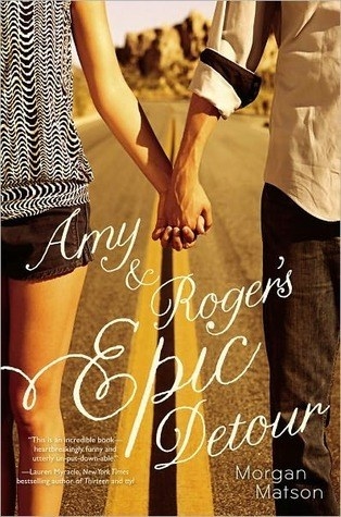 Book cover of two teens holding hands across a road with title text atop