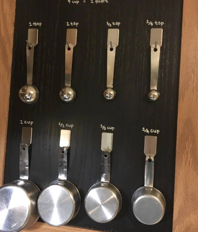 measuring cups and spoons hanging from adhesive hooks