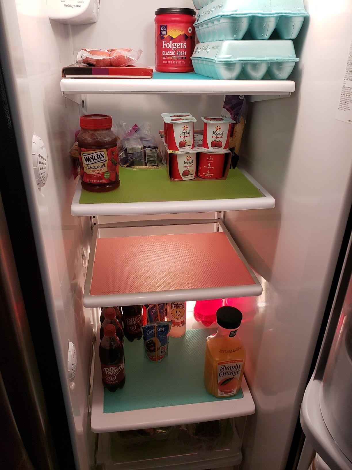 reviewer&#x27;s fridge with shelves lined with mats