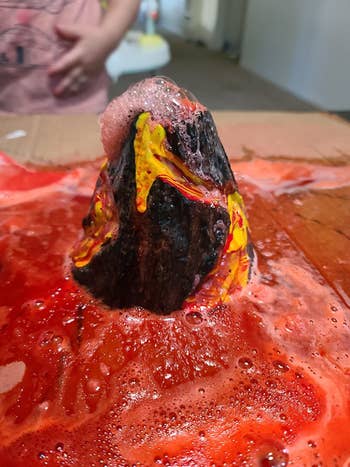 Reviewer's photo showing the volcano with with lava flowing around it