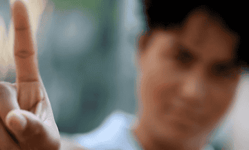 GIF of woman swaying finger &quot;NO&quot;.