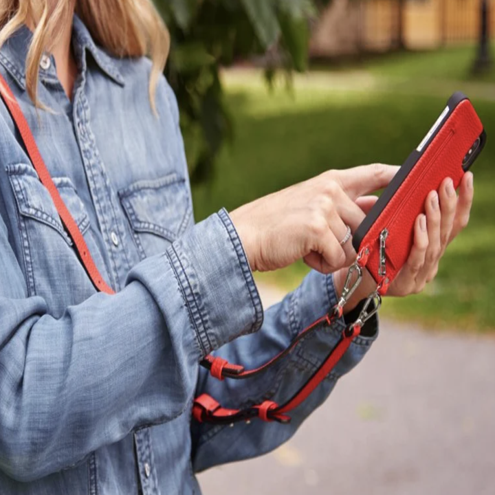 Model holding up phone placed in purse-style phone case