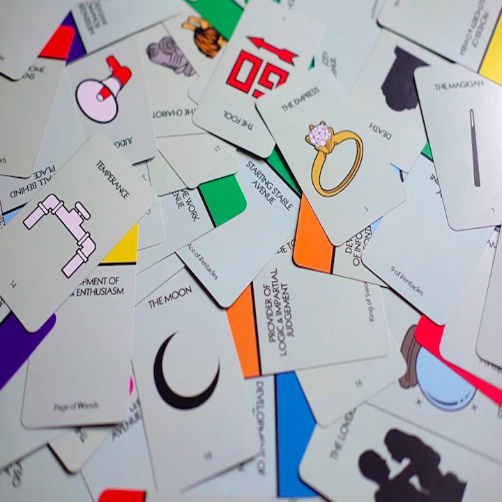 a pile of tarot cards with designs on them that actually look like the Monopoly game