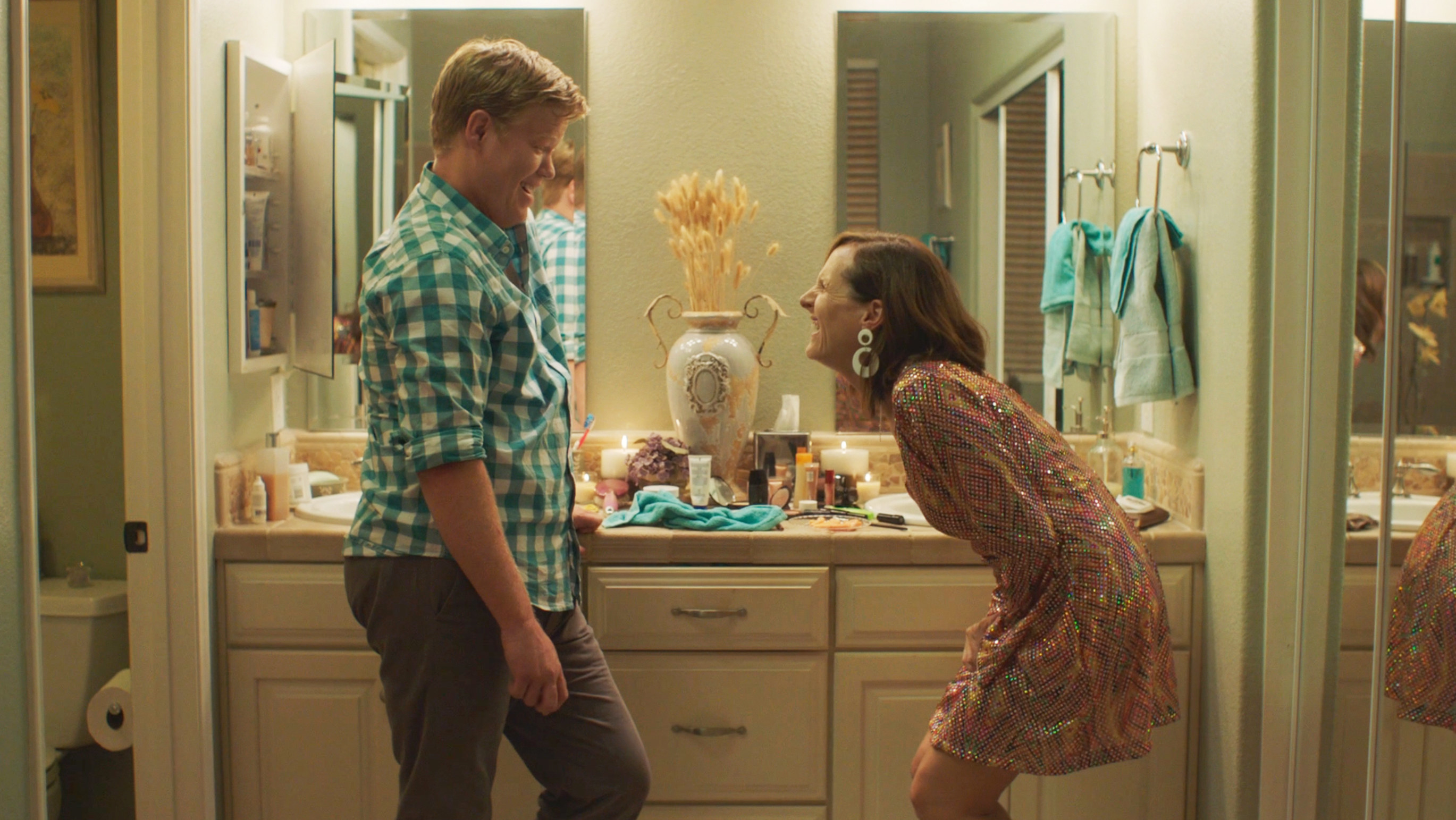 Jesse Plemons and Molly Shannon laugh together in a bathroom