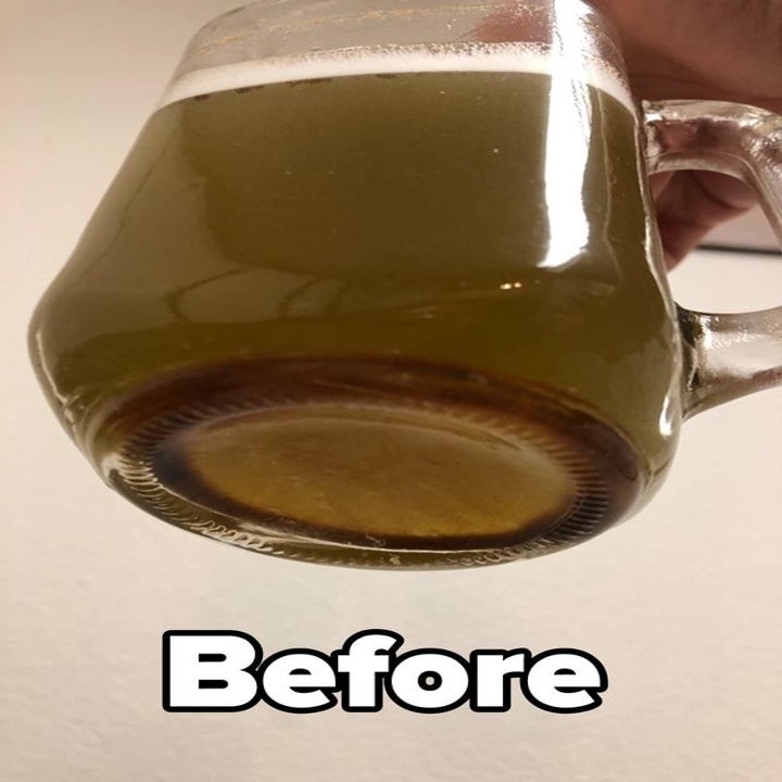a reviewer photo of a glass of brown water and text reading "before" 