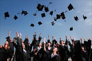 University students throwing their hats into the air