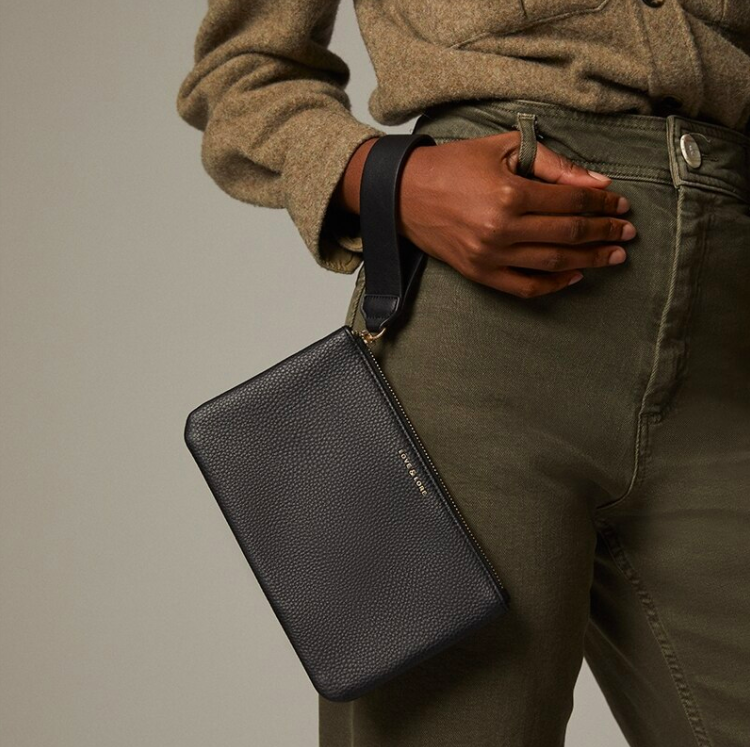 A person wearing the pouch as a wristlet