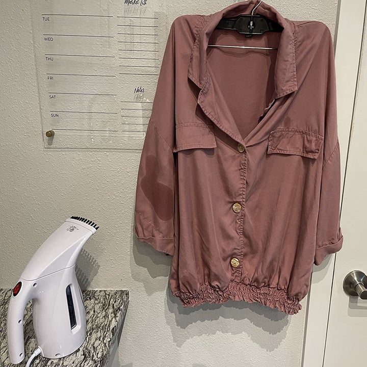the shirt next to the smaller-than-an-iron steamer, with wrinkles gone