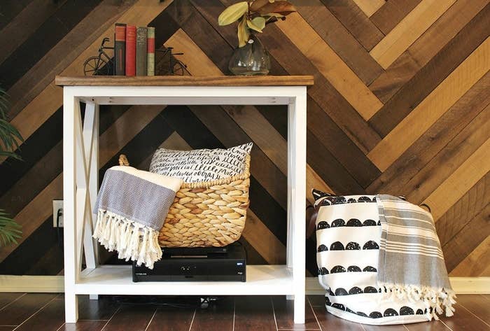 herringbone wall with a small table styled against it