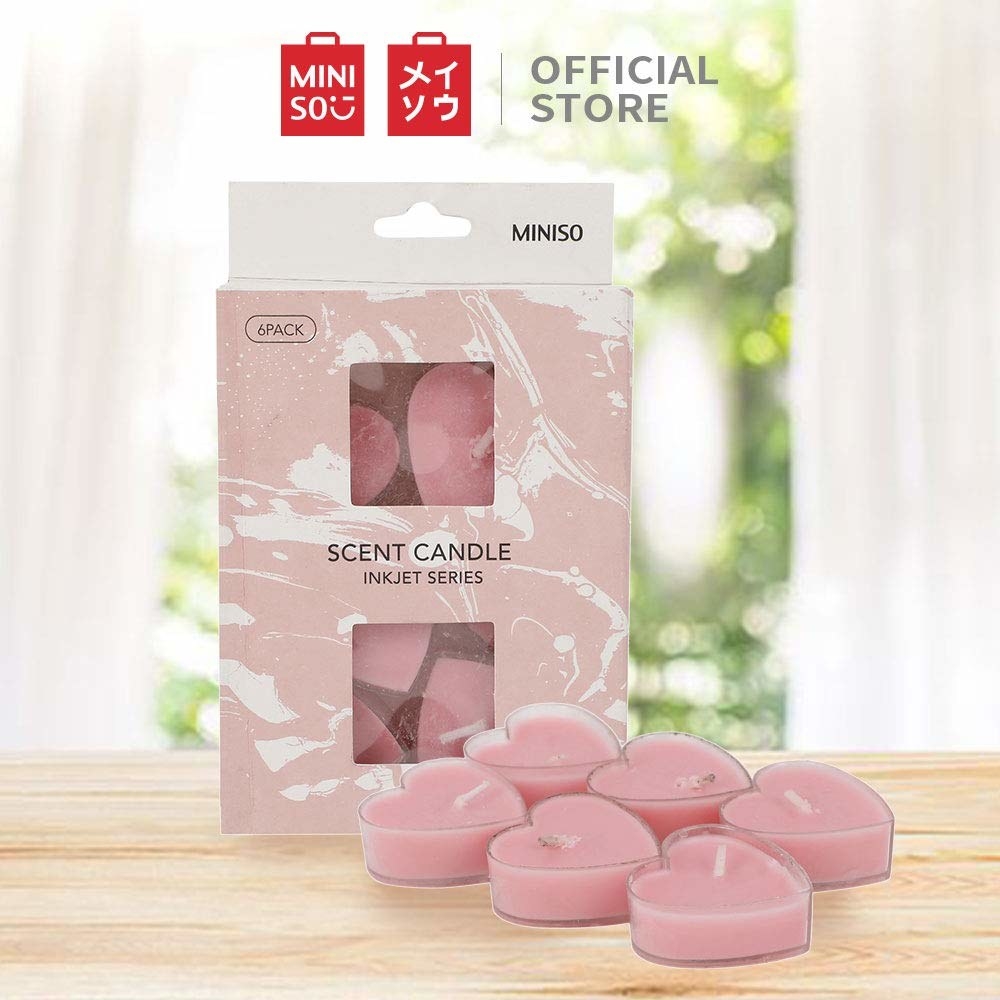 A pack of 6 heart-shaped scented candles in pink