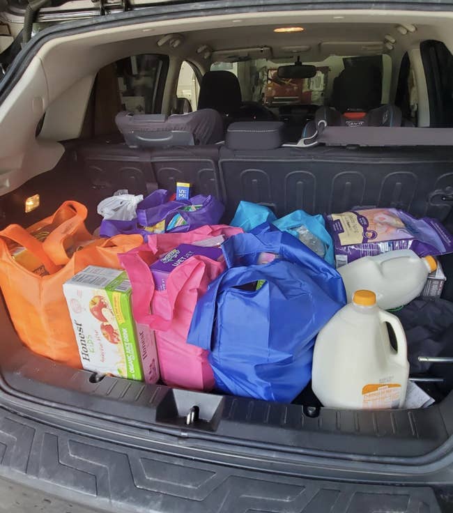 Reviewer image of colorful bags full of groceries in a car trunk
