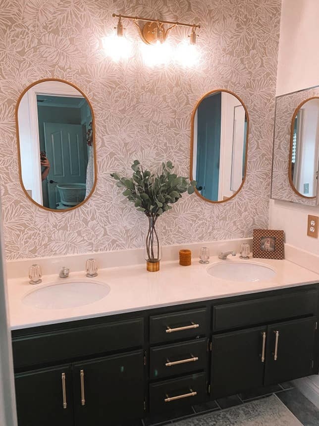 different reviewer's bathroom with black cabinets and gold pulls installed on drawers and cabinets