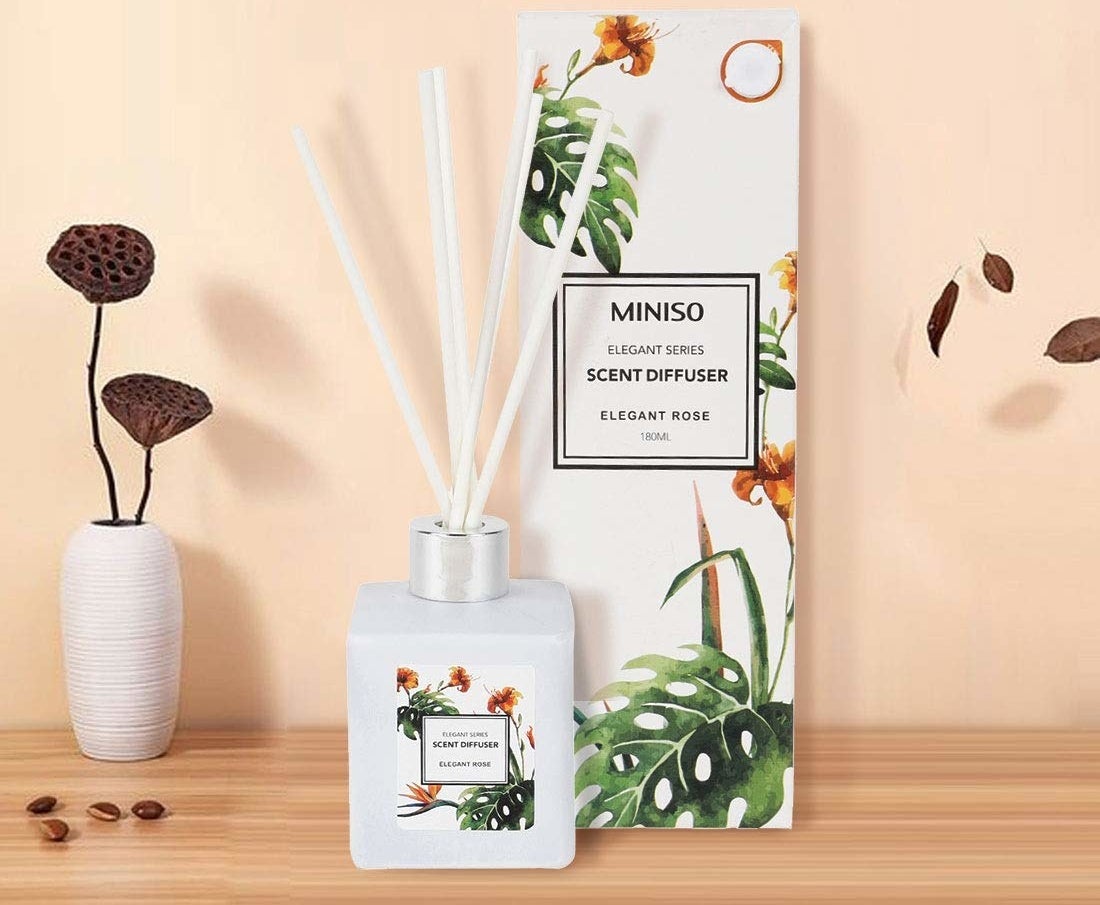 A reed stick diffuser in white with the scent of rose