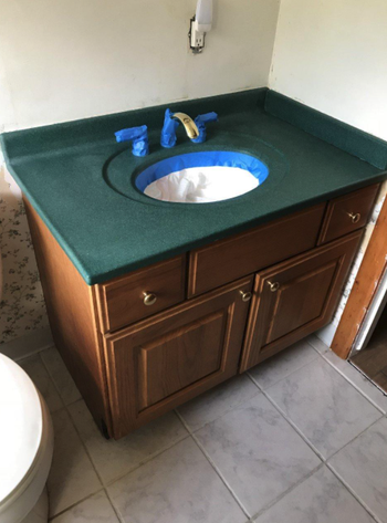 Reviewer pic of aged green bathroom vanity top 