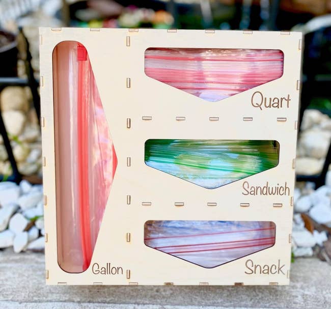 the wooden holder with space for snack sandwich quart and gallon sized plastic bags