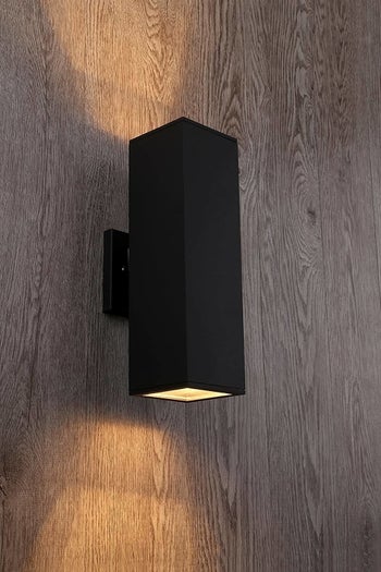 matte black rectangular sconce hung on wall 