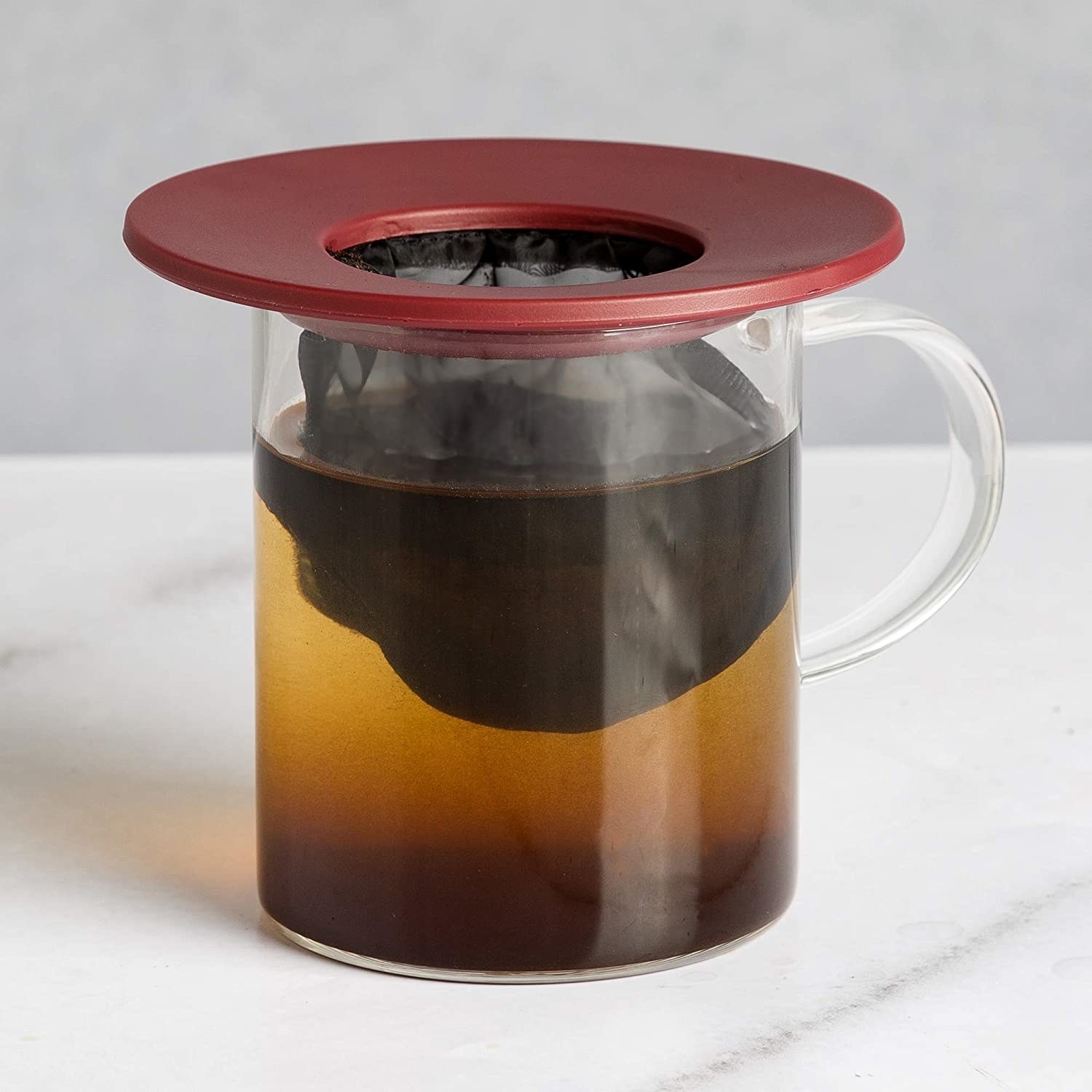 A mug with the coffee brewer placed on the top