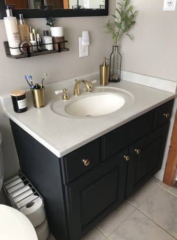 Reviewer pic of transformed bathroom vanity with the help of the spray paint
