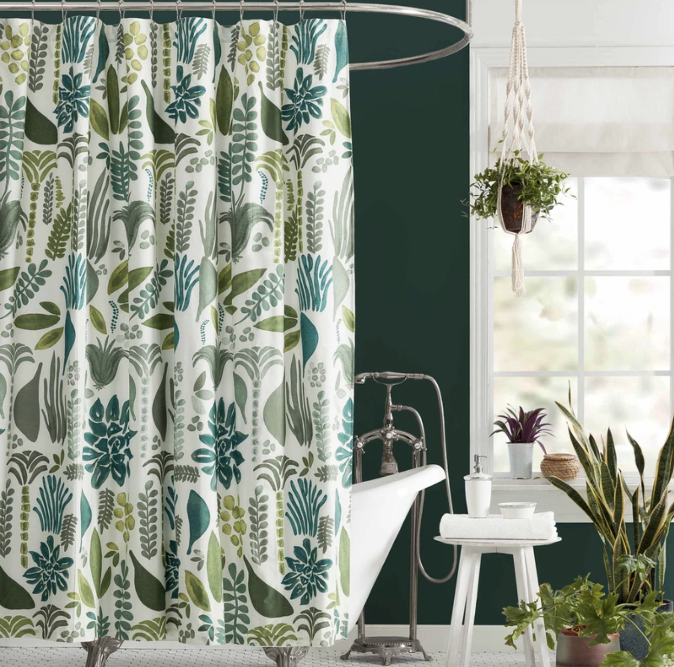 The shower curtain covered in a leafy pattern is shown in a bathroom