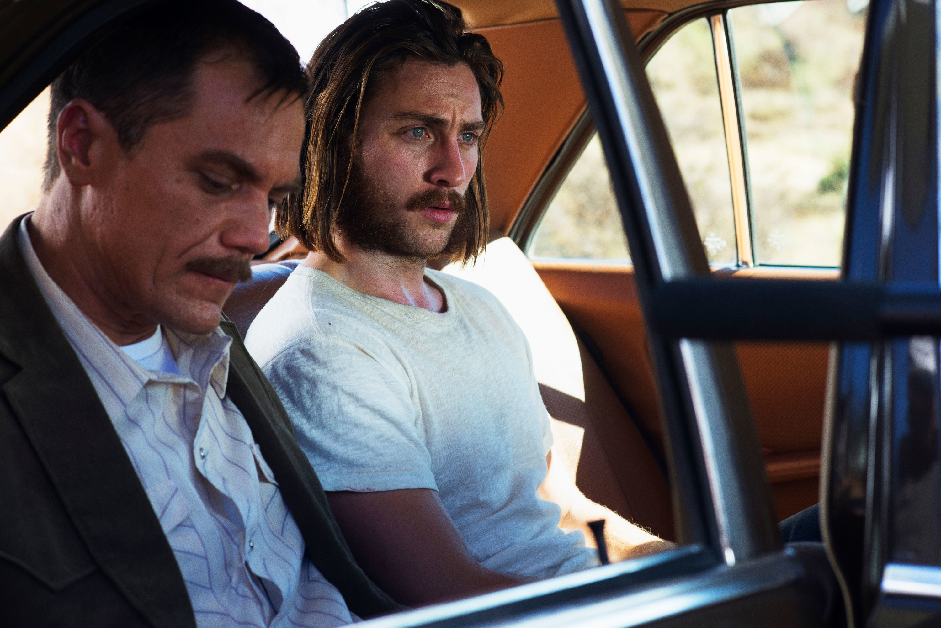 Michael Shannon and Aaron Taylor-Johnson sitting in a car together
