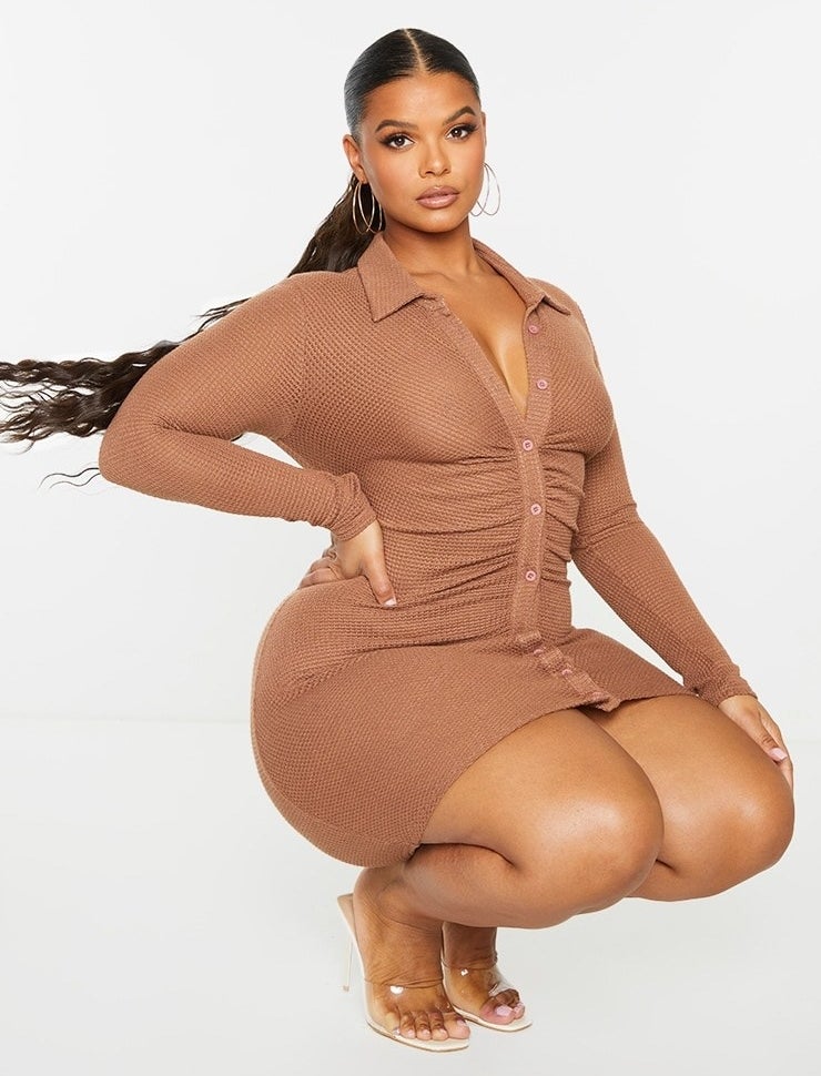 Model wearing brown button and ruched dress with clear shoes