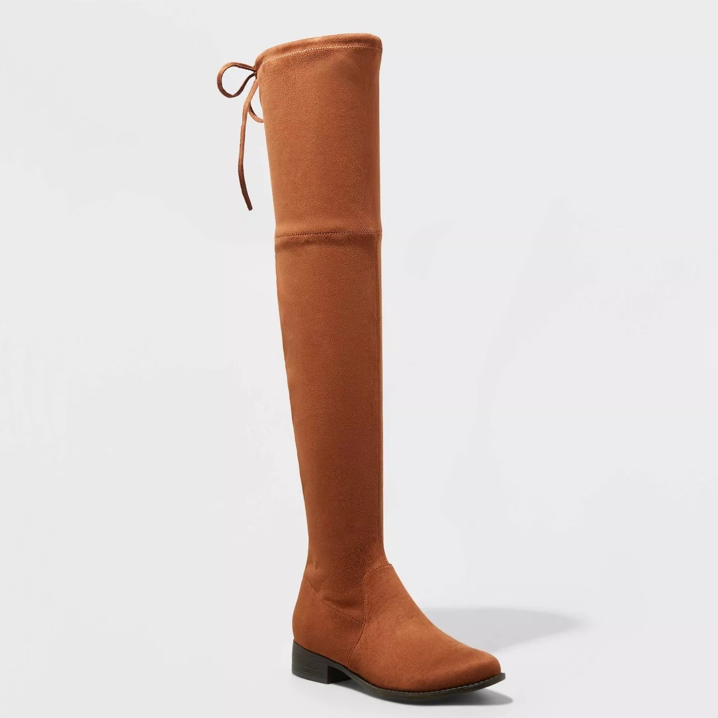 Camel colored boots with black sole, tie string detail at the top of the boot