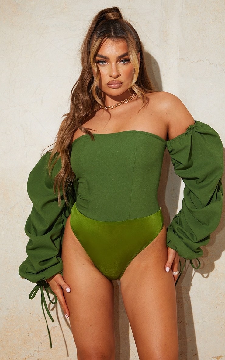 Model wearing green bodysuit