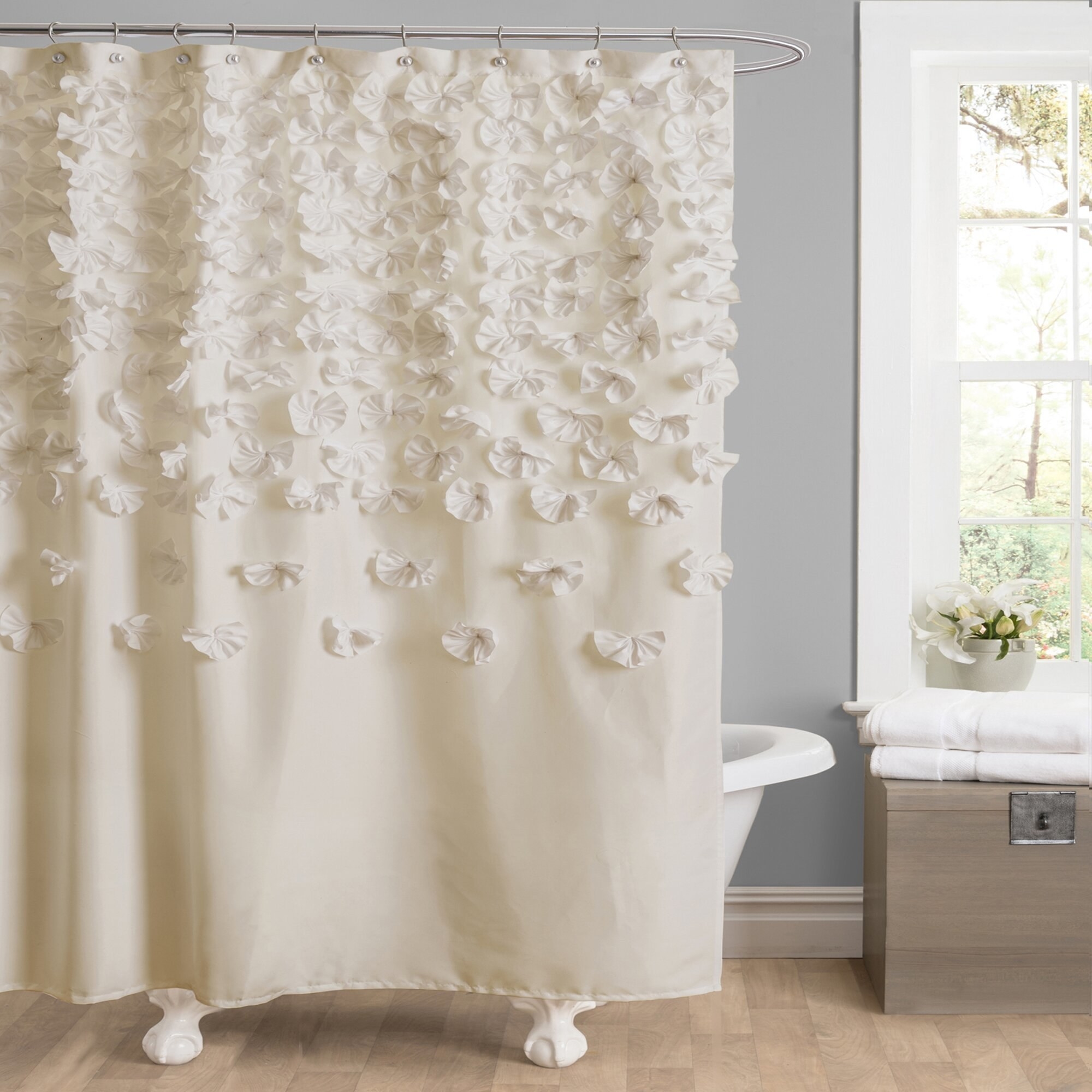 A white curtain with flower ruffles sprinkling down it
