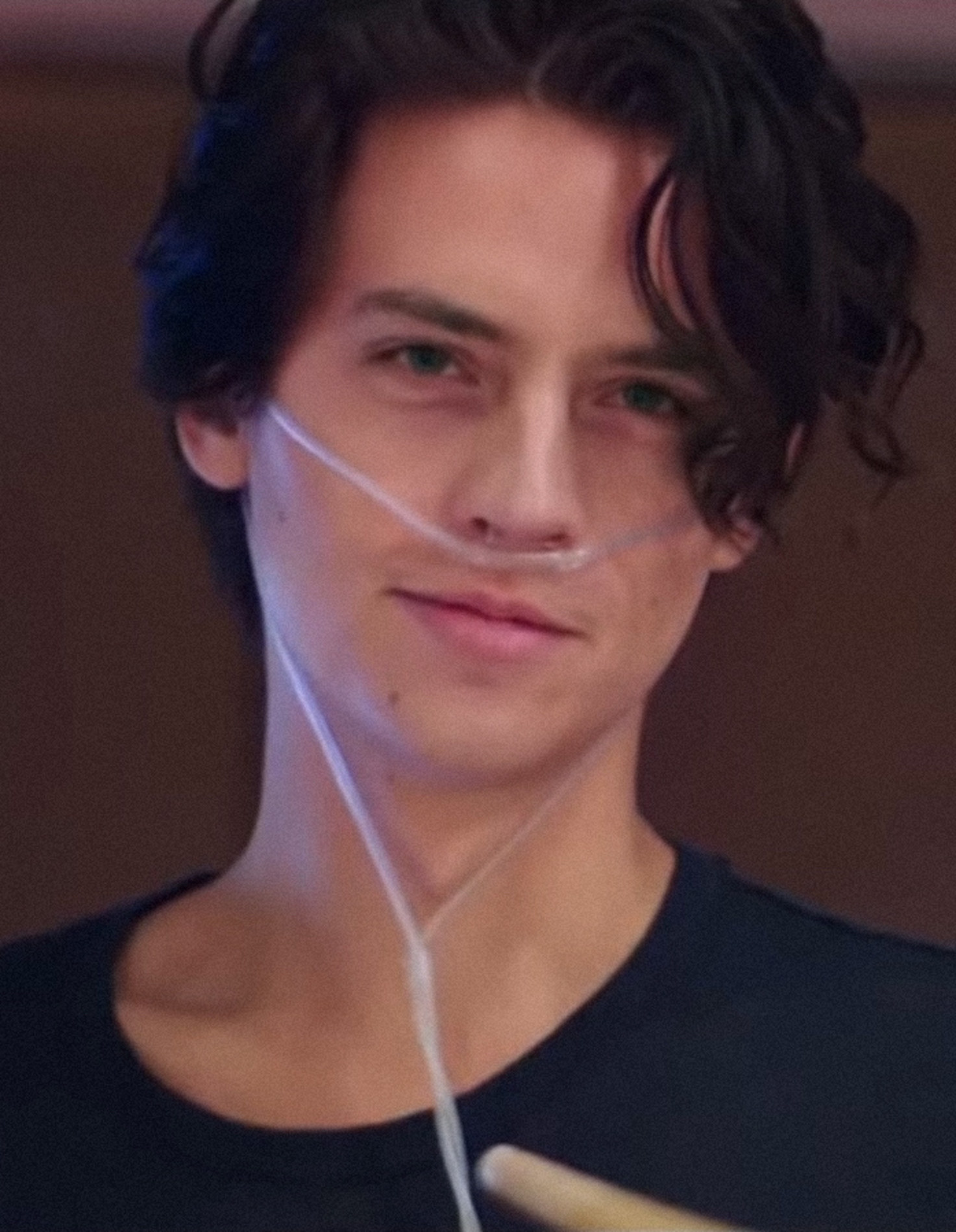Cole Sprouse wearing an oxygen tube inside of his nose