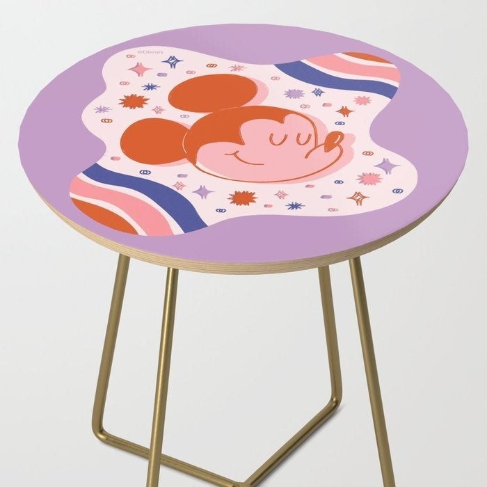 a round end table with a pink galactic mickey table top
