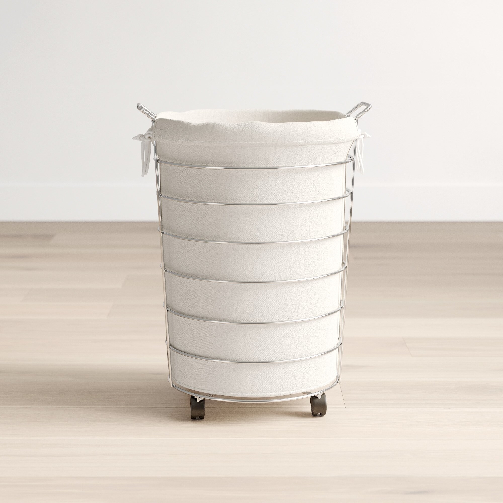 A metallic chrome skeleton hamper with a visible canvas bag on wheels