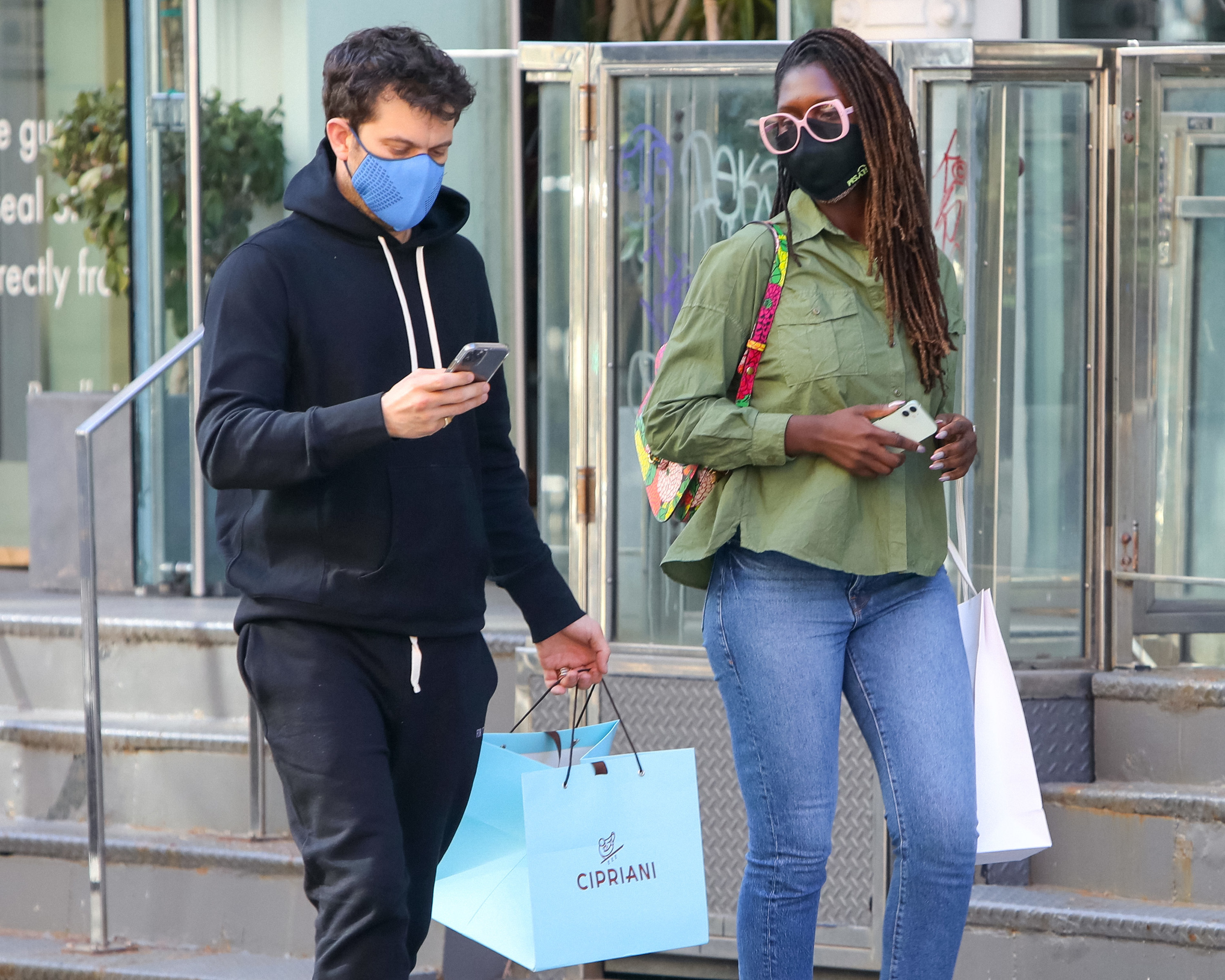 Jackson and Turner-Smith walk down the street while wearing masks