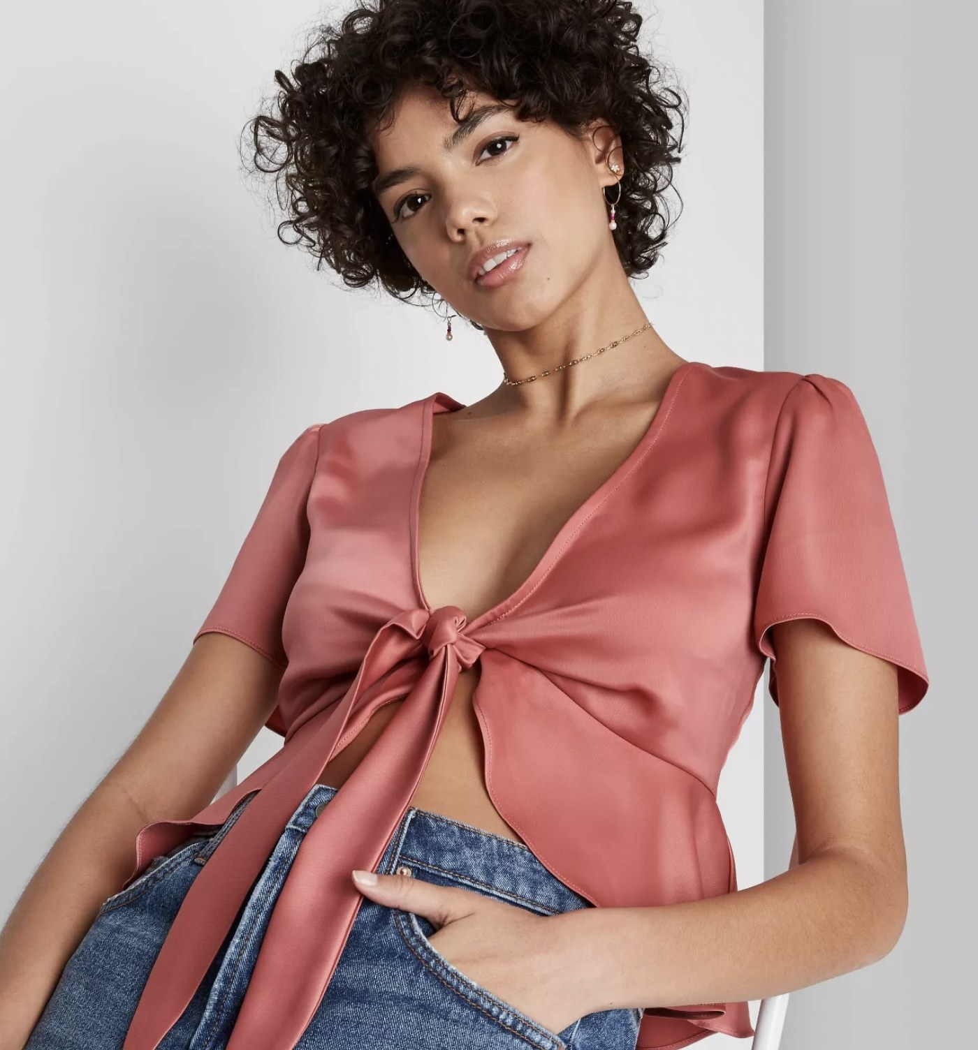 model wearing satin tie-front blouse in rose