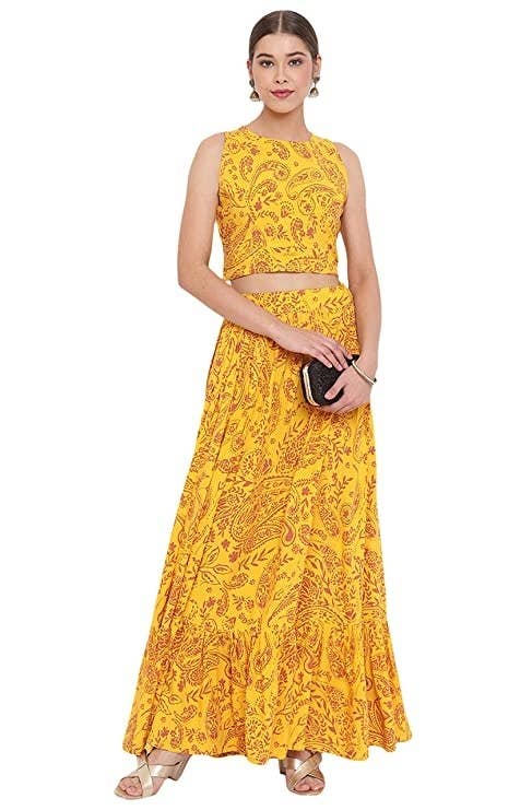 A bright yellow top and skirt set with a maroon pattern on it
