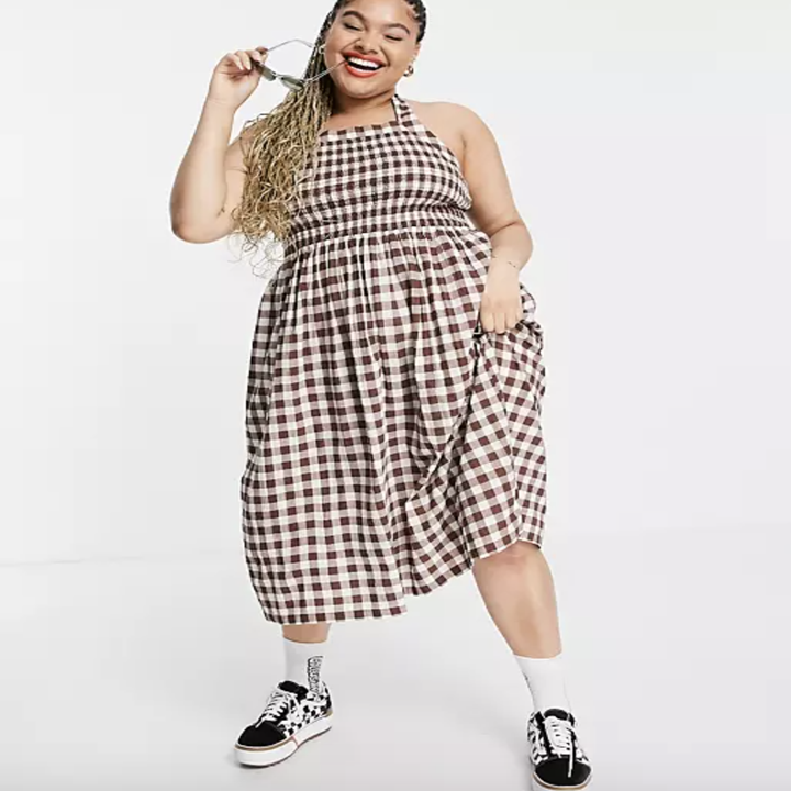 model wearing mid-length halter gingham dress