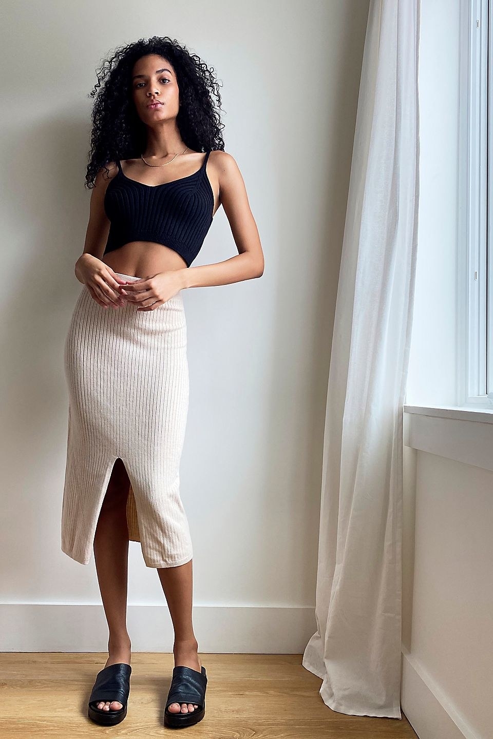 model wearing the ribbed knit bodycon skirt in tan with slit up the middle