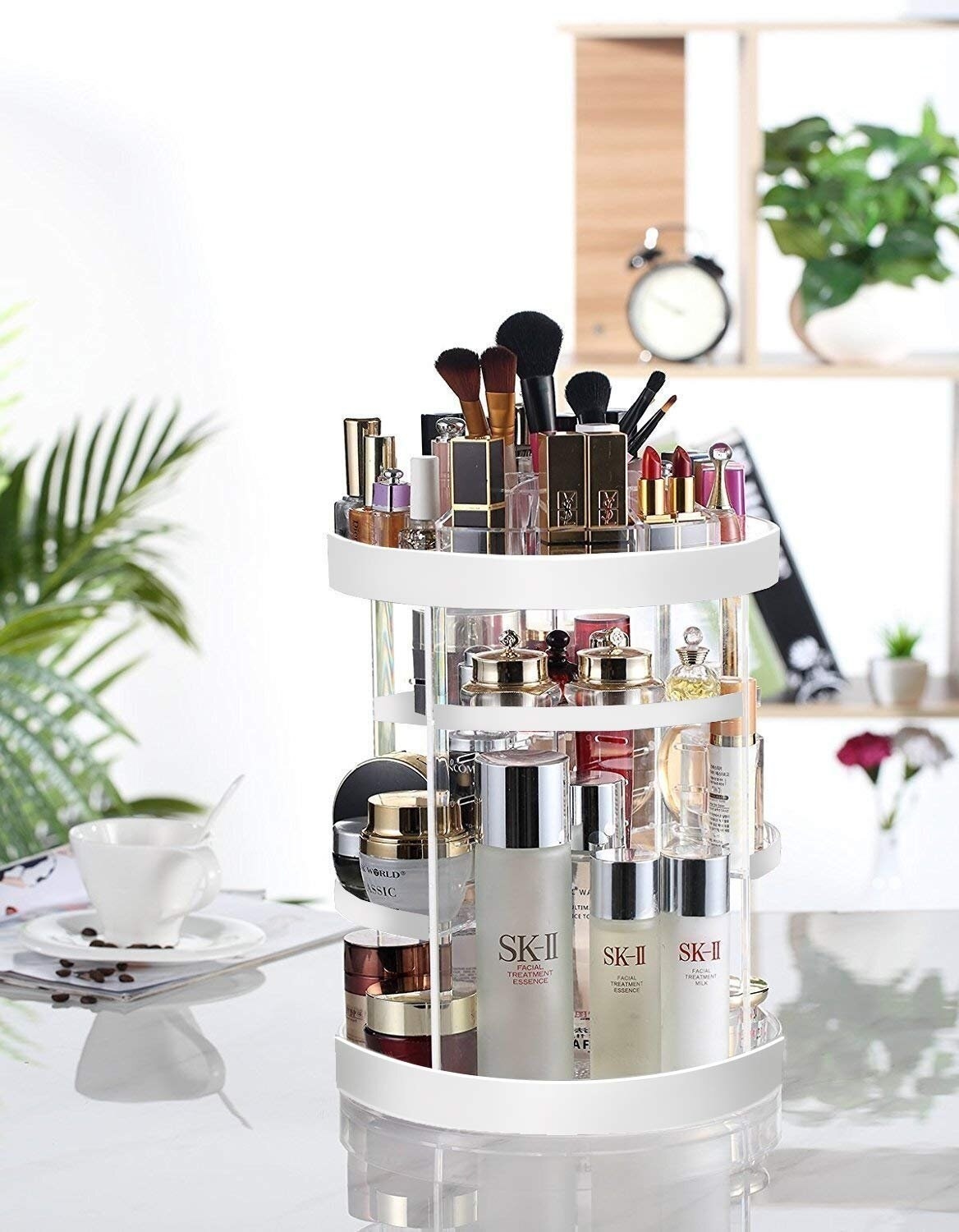 A circular item filled with makeup, with two shelves filled with cosmetics