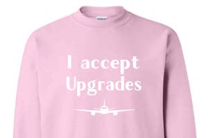 The sweatshirt in pink that reads, "I accept upgrades"