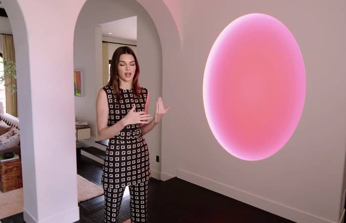 Kendall standing next to her James Turrell piece and discussing it