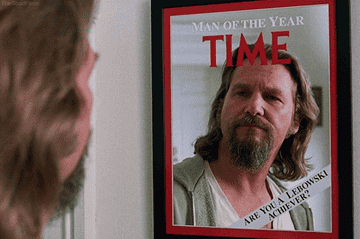 The Dude looks at his reflection is a mirror shaped like Time Magazine