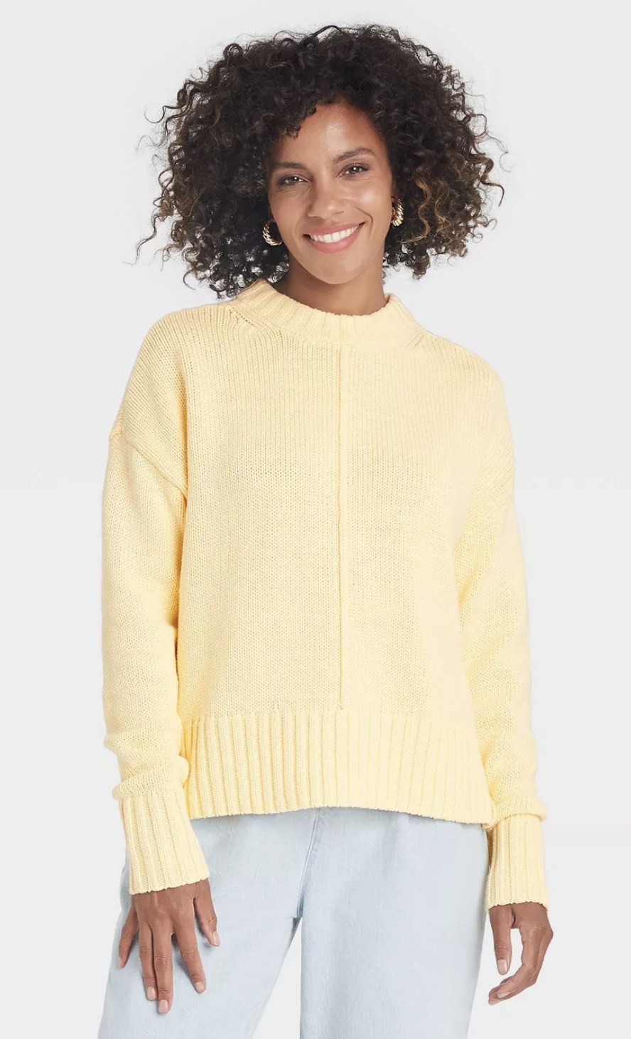 model wearing the sweater in pale yellow