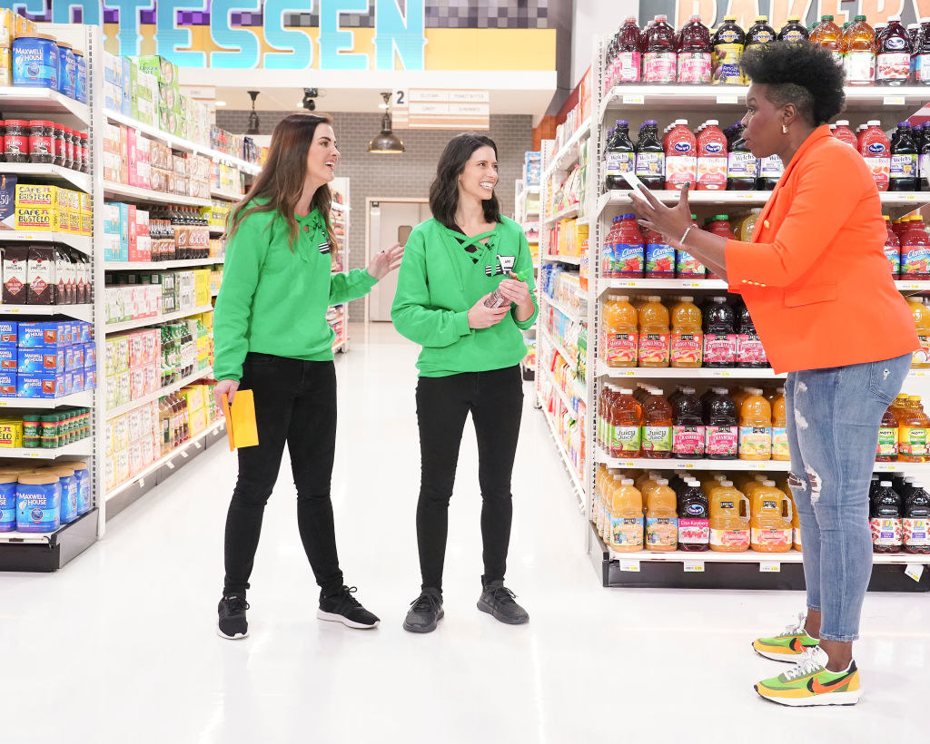 Host Leslie Jones talks to two contestants on the reboot of Supermarket Sweep