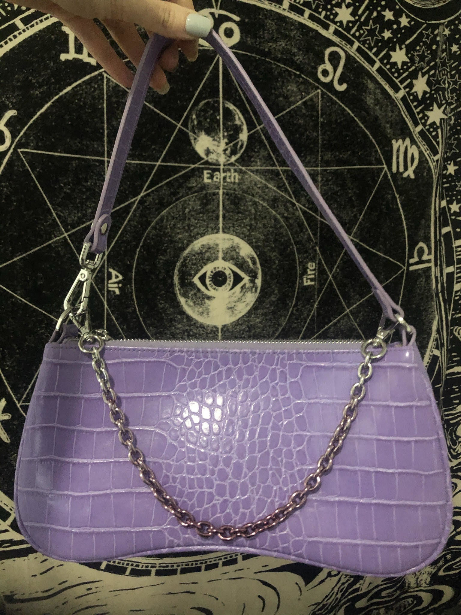 purple baguette shaped bag with faux croc effect and a chain